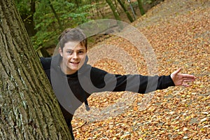 Teenage boy in autumn forest