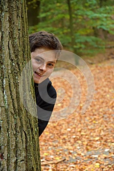 Teenage boy in autumn forest