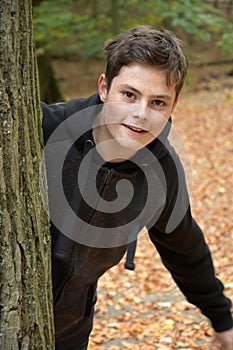 Teenage boy in autumn forest