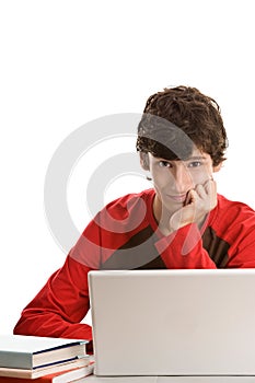 Teenage boy behind desk with laptop