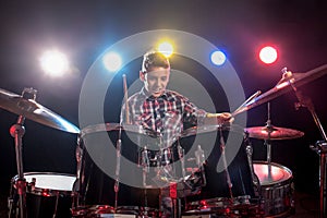 Teenage boy behind drum kit