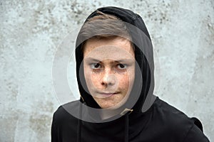 Teenage boy in black hoodie