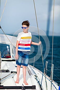 Teenage boy on board of sailing yacht