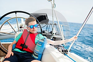 Teenage boy on board of sailing yacht