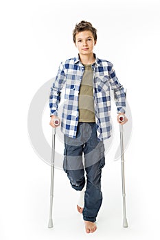 Teenage Boy with crutches and a bandage on his right leg