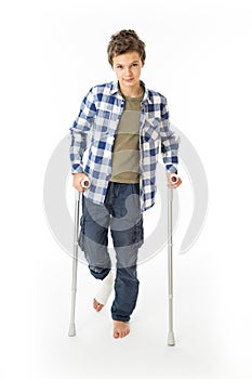 Teenage Boy with crutches and a bandage on his right leg