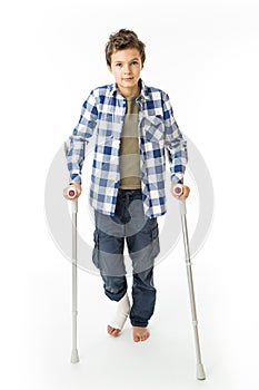 Teenage Boy with crutches and a bandage on his right leg