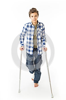 Teenage Boy with crutches and a bandage on his right leg