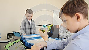 Teenage boy demonstrates the plastic helicopter made by him at the engineering lesson slow motion