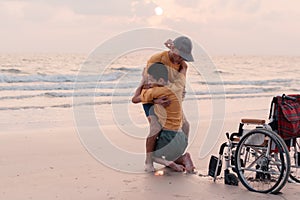 Teenage boy with disability on the beach