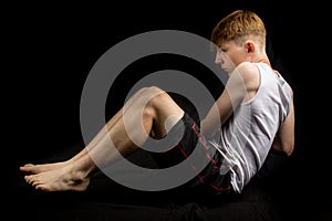 Teenage boy doing Russian Twists