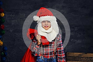 Teenage boy dressed in Santa`s holiday costume.