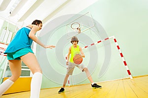 Teenage boy dribbling basketball during the match