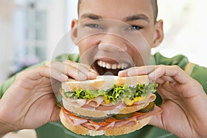 Teenage Boy Eating Sandwich