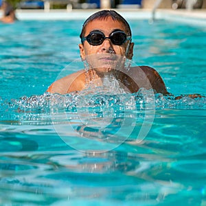 Teenage boy emerging from the water surface