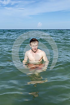 Teenage boy enjoys swimming in the ocean