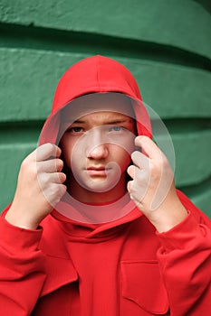 Teenage boy in fashionable red hoodie