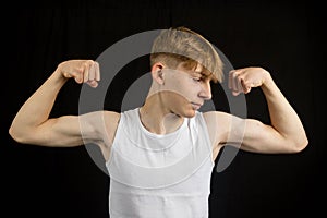 Teenage boy flexing both his arms
