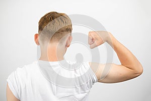 Teenage boy flexing his bicep