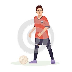 Teenage boy football player, in a red sports shirt, kicks a soccer ball. Kid sportsman playing football game, dynamic