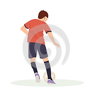 Teenage boy football player, in a red sports shirt, kicks a soccer ball. Kid sportsman playing football game, dynamic