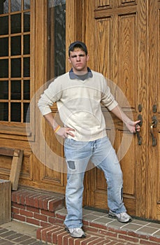 Teenage boy in front of oak doors