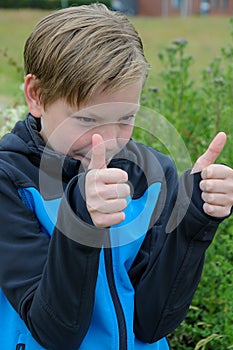 Teenage boy with  gesture thumbs up