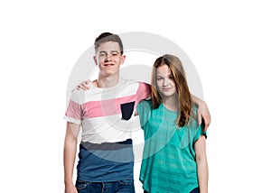 Teenage boy and girl, arms around each other, isolated.