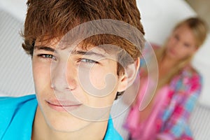 Teenage boy and girl in bedroom photo