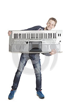 Teenage boy has fun with keyboard in studio