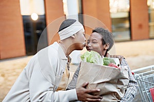 Teenage Boy Helping Mom with Groceries