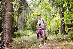 Teenage boy hiking in forest. Summer vacation.