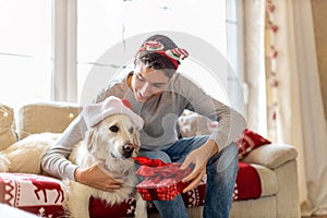 Teenage boy and his dog enjoying Christmas together