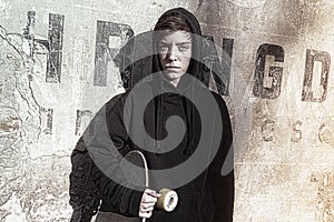 Teenage boy holding his long board