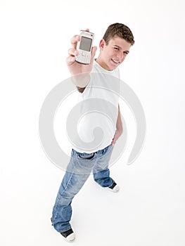 Teenage boy holding up cellular phone and smiling