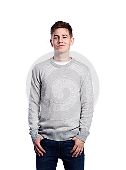 Teenage boy in jeans and sweater. Studio shot, isolated.