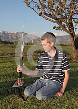 Teenage boy launching a model rocket