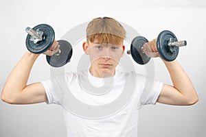 Teenage boy lifting weights