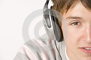 Teenage Boy Listening To Music On Headphones