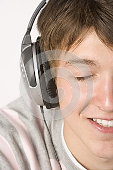 Teenage Boy Listening To Music On Headphones