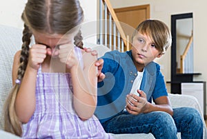 Teenage boy and little girl quarrelling at home