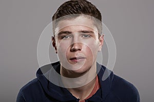 Teenage boy looking at camera, head and shoulders portrait