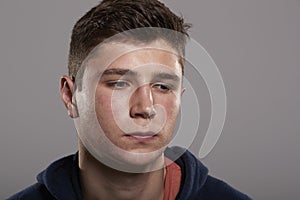 Teenage boy looking down, head and shoulders portrait