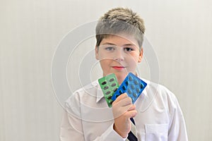 teenage boy with the medicine in his hands