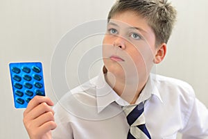 teenage boy with the medicine in his hands