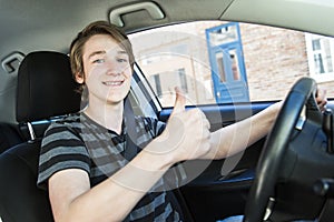 Teenage boy and new driver behind wheel of his car