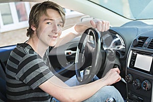 Teenage boy and new driver behind wheel of his car