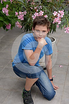 Teenage boy and pink oleander