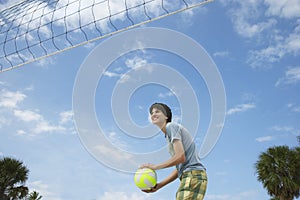 Teenage Boy Playing Beach Volleyball