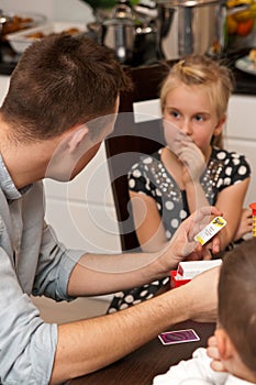 Teenage boy playing card game with his sister